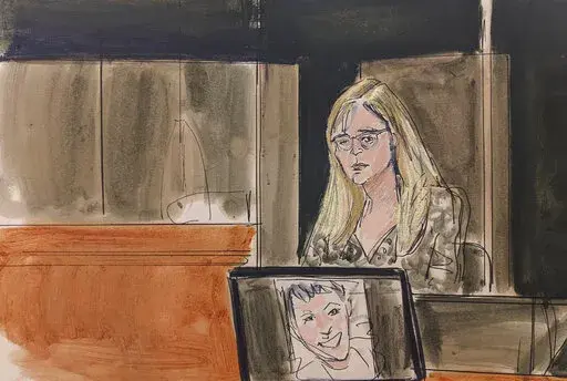 In this courtroom sketch, Annie Farmer testifies on the witness stand during the Ghislaine Maxwell sex abuse trial, Friday, Dec. 10, 2021, in New York. A photo of Maxwell appears on a screen at foreground.(Elizabeth Williams via AP)