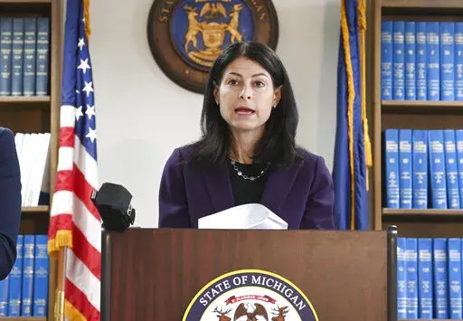 Attorney General Dana Nessel announces charges for several security guards from Northland Mall in the 2014 death of McKenzie Cochran during a news conference in Detroit on Thursday, Oct. 14, 2021.  Nessel is asking federal prosecutors, Thursday, Jan. 13, 2022,  to open a criminal investigation into 16 Republicans who submitted false certificates stating they were the state’s presidential electors despite Joe Biden’s 154,000-vote victory in 2020. (Max Ortiz/Detroit News via AP)
