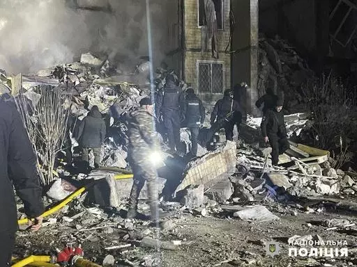 In this photo provided by the Ukrainian Police Press Office, emergency workers work on the site of a destroyed multi-store building after a Russian attack on residential neighbourhood in Odesa, Ukraine, Saturday, March 2, 2024. (Ukrainian Police Press Office via AP)