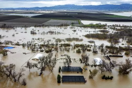 Floodwaters cover a property along River Rd. in Monterey County, Calif., as the Salinas River overflows its banks on Jan. 13, 2023. California officials announced on Thursday, Jan. 26, 2023, that public water agencies will get 30% of what they asked for instead of 5%. The increase is because of a spate of recent storms that have helped replenish some of the state's reservoirs that had been impacted by a severe drought. (AP Photo/Noah Berger, File)