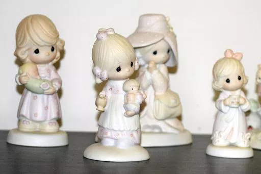 A selection of Precious Moments figurines sit on a shelf, Thursday, May 23, 2024, in Blaine, Minn. Sam Butcher, the artist who created the Precious Moments figurines depicting angelic teardrop-eyed children, died early Monday, May 20, 2024, surrounded by family. He was 85. (Lissa Forliti-Aska via AP)