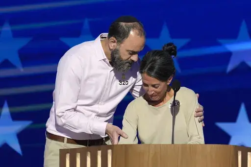 Jon Polin, left, and Rachel Goldberg, parents of Hersh Goldberg-Polin, speak on stage during the Democratic National Convention Wednesday, Aug. 21, 2024, in Chicago. (AP Photo/J. Scott Applewhite)