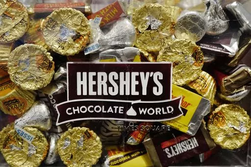 A mixture of Hershey's chocolates is displayed in the company's Times Square store, March 1, 2017, in New York. Hershey is cautioning on its 2024 profit growth as the company contends with rising cocoa costs that are leading to higher prices for chocolate. Cocoa futures prices have doubled over the past year and hit an unprecedented $5,874 per metric ton Friday, Feb. 9, 2024, in intraday trading. (AP Photo/Mark Lennihan, File)