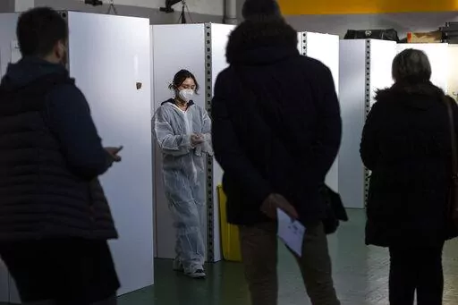 A medical worker prepares to perform nasal tests, at a COVID-19 testing site, in Nantes, western France, Friday, Dec. 31, 2021. An unprecedented number of coronavirus infections is once again exposing the underfunding and shortcomings of public health care systems, even in developed parts of Europe. (AP Photo/Jeremias Gonzalez, File)