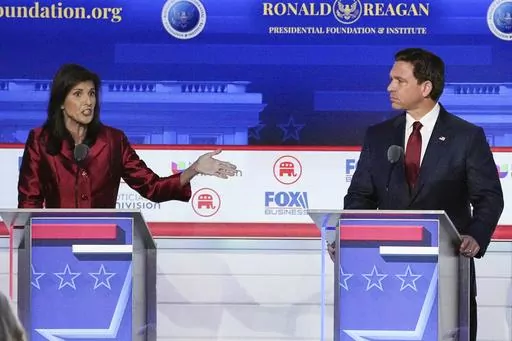 Republican presidential candidate and former U.N. Ambassador Nikki Haley, left, with Florida Gov. Ron DeSantis, speaks during a Republican presidential primary debate hosted by FOX Business Network and Univision, Sept. 27, 2023, at the Ronald Reagan Presidential Library in Simi Valley, Calif. Haley has been rising with donors and voters thanks in part to strong debate performances and the campaign's increased focus on foreign policy. That's come partly at the expense of Florida Gov. Ron DeSantis