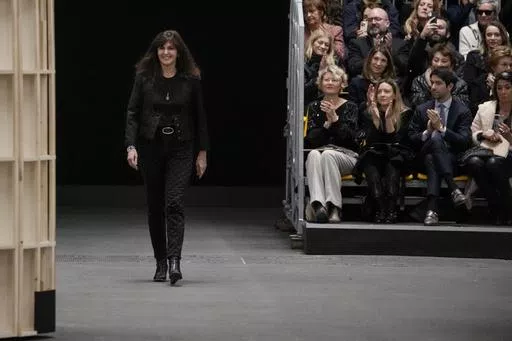 Designer Virginie Viard accepts applause at the end of the Chanel Haute Couture Spring-Summer 2023 collection presented in Paris, on Jan. 24, 2023. Virginie Viard, the artistic director of Chanel who replaced Karl Lagerfeld after his death, has left, the French fashion house said on Thursday. Chanel did not immediately announce a replacement for the the 62-year-old Viard, who worked with Lagerfeld for more than two decades. (AP Photo/Christophe Ena, File)