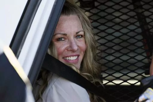 Lori Vallow Daybell sits in a police car after a hearing at the Fremont County Courthouse in St. Anthony, Idaho, on Aug. 16, 2022. The sister of Tammy Daybell, who was killed in what prosecutors say was a doomsday-focused plot, told jurors Friday, April 28, 2023, that her sister's funeral was held so quickly that some family members couldn't attend. The testimony came in the triple murder trial of Vallow Daybell, who is accused along with Chad Daybell in Tammy's death and the deaths of Vallow Da