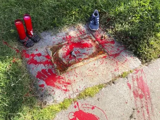 Red painted handprints cover the empty spot at a park in Albuquerque, New Mexico, on Thursday, July 1, 2021, where a historical marker for the Indigenous children who died while attending a boarding school nearby was removed. The U.S. Interior Department is expected to release a report Wednesday, May 11, 2022, that it says will begin to uncover the truth about the federal government's past oversight of Native American boarding schools.  (AP Photo/Susan Montoya Bryan,File)