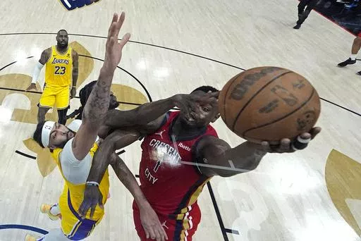 New Orleans Pelicans forward Zion Williamson (1) goes to the basket against Los Angeles Lakers forward Anthony Davis and forward Taurean Prince in the first half of an NBA basketball play-in tournament game Tuesday, April 16, 2024, in New Orleans. Looking on at rear left is Lakers' LeBron James.(AP Photo/Gerald Herbert)