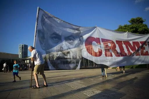 Israelis carry a banner showing Israeli Prime Minister Benjamin Netanyahu during a protest against the Israel Jewish nation bill, in Tel Aviv, Israel, July 30, 2018. Netanyahu is set to return to power, from where he could try to make his years-long legal troubles disappear through new legislation advanced by his far-right and ultra-Orthodox allies. Critics say such a legal crusade is an assault on Israel’s democracy. (AP Photo/Oded Balilty, File)
