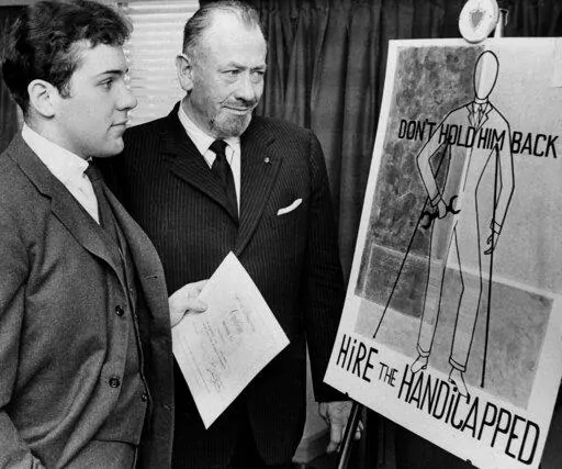 FILE — Nobel prize-winning author John Steinbeck, right, admires a prize-winning poster by his son, Thomas Steinbeck, in Hartford, Conn., March 22, 1963. A tender and touching letter that author John Steinbeck penned to his teenage son, offering fatherly advice after the young man confided that he was in love for the first time, is going up for auction. "If you are in love — that's a good thing — that's about the best thing that can happen to anyone. Don't let anyone make it small or light