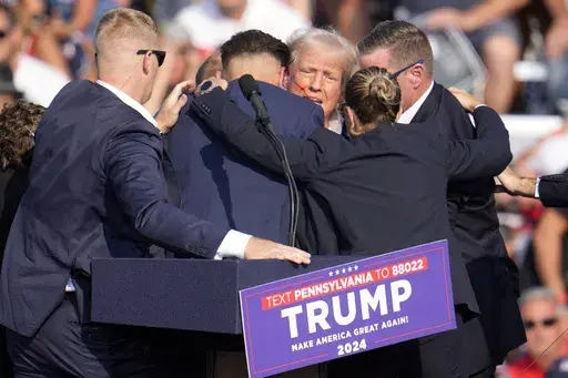 Republican presidential candidate former President Donald Trump is surrounded by Secret Service at a campaign event in Butler, Pa., July 13, 2024. A senior FBI official says the gunman in the assassination attempt of former President Donald Trump searched online for events of both Trump and President Joe Biden and saw the Pennsylvania campaign rally where he opened fire last month as a “target of opportunity." (AP Photo/Gene J. Puskar, File)