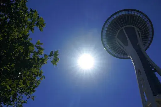 The sun shines near the Space Needle, Monday, June 28, 2021, in Seattle as Seattle and other cities broke all-time heat records, with temperatures soaring well above 100 degrees Fahrenheit (37.8 Celsius). Weather extremes like this will increase in frequency and intensity in North America the coming years as global warming accelerates, according to a United Nations Intergovernmental Panel on Climate Change report. (AP Photo/Ted S. Warren,File)