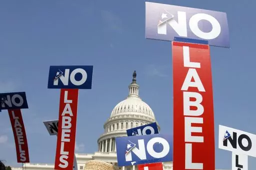 People with the group No Labels hold signs during a rally on Capitol Hill in Washington, July 18, 2011. More than 15,000 people in Arizona have registered to join a new political party floating a possible bipartisan “unity ticket” against Joe Biden and Donald Trump. (AP Photo/Jacquelyn Martin, File)