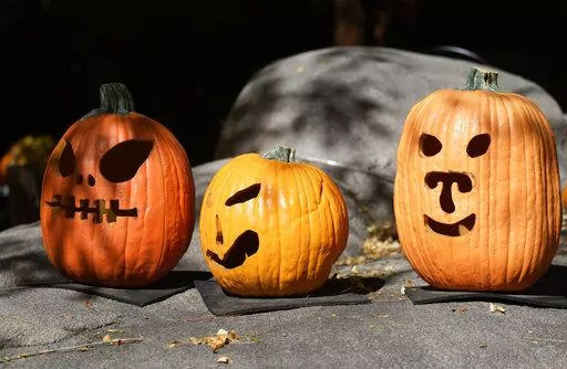 A display of pumpkins prepared for Halloween welcomes visitors at the Denver Zoo Tuesday, Oct. 18, 2022, in Denver. Forecasters predict that the warm weather will remain in place over the intermountain West through the week ahead. (AP Photo/David Zalubowski)