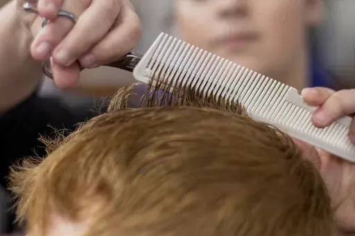 A barber cuts a client's hair at a barber shop in Chattanooga, Tenn., on Tuesday, March 17, 2020. (C.B. Schmelter/Chattanooga Times Free Press via AP, File)