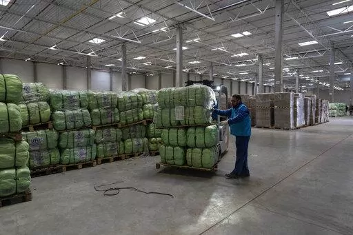 UNHCR staff load a truck with supplies for Ukraine in an aid warehouse at Rzeszow airport, in Rzeszow, southeastern Poland, Wednesday, March 16, 2022. (AP Photo/Petros Giannakouris)