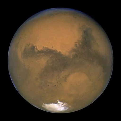 This Aug. 26, 2003, image made available by NASA shows Mars as it lines up with the Sun and the Earth. A new study suggests water on Mars may be more widespread and recent than previously thought. Scientists reported the finding from China's Mars rover in Science Advances on Friday, April 28, 2023. (NASA/J. Bell - Cornell U./M. Wolff - SSI via AP, File)