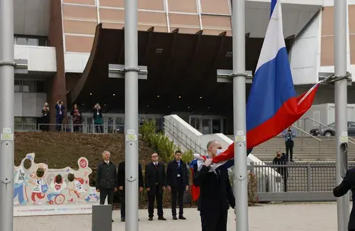 Employees of the Council of Europe remove the Russian flag from the Council of Europe building, Wednesday, March 16, 2022 in Strasbourg. The Council of Europe expelled Russia from the continent's foremost human rights body in an unprecedented move over its invasion and war in Ukraine. The 47-nation organization's committee of ministers said in statement that "the Russian Federation ceases to be a member of the Council of Europe as from today, after 26 years of membership." (AP Photo/Jean-Francoi