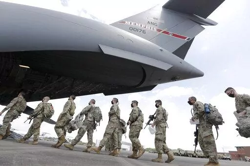 Tennessee National Guard troops board a plane in Smyrna, Tenn., to go to Washington, Thursday, June 4, 2020.  Three current and former members of the Tennessee National Guard are “safe” and “accounted for,” despite a Russian newspaper’s false report, Thursday, March, 17, 2022, that the men were killed while fighting in Ukraine.  All three individuals named in the report, are alive and well — and no U.S. military personnel are currently on orders in Ukraine, National Guard Bureau spok