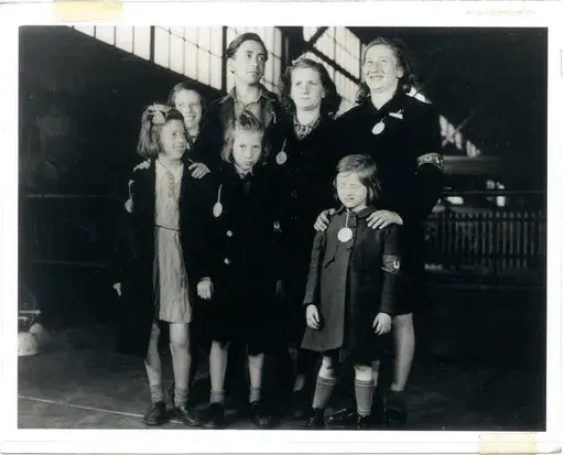 In this May 26, 1946, photo, Ginger Lane, bottom right, and her siblings arrive in New York City as Holocaust survivors who were hidden in a fruit orchard near Berlin by non-Jews. Their mother was killed at the death camp at Auschwitz. Lane has since made it her lifelong mission to educate others of this painful past. (Courtesy Ginger Lane via AP)
