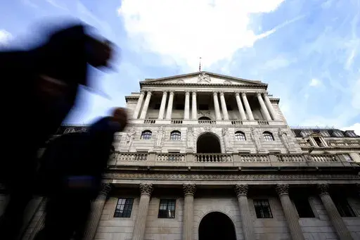 Pedestrians walk past The Bank of England in London, Thursday, Sept. 22, 2022. Britain's central bank is under pressure to make another big interest rate hike Thursday. Inflation in the United Kingdom is outpacing other major economies, but the U.S. Federal Reserve and other banks are moving faster to get prices under control. (AP Photo/Kirsty Wigglesworth)
