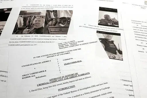 The affidavit to support the arrest of Arian Taherzadeh and Haider Ali is photographed Wednesday, April 6, 2022. Federal prosecutors have charged the two men they say were posing as federal agents, giving free apartments and other gifts to U.S. Secret Service agents, including one who worked on the first lady's security detail. Both were taken into custody as more than a dozen FBI agents charged into a luxury apartment building in Southeast Washington on Wednesday evening. (AP Photo/Jon Elswick)