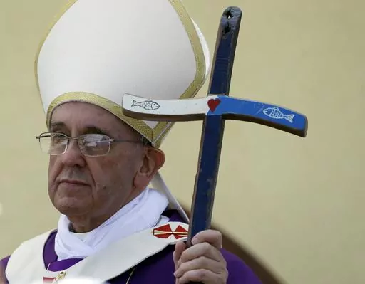 Pope Francis holds his pastoral staff, made from recycled wood from broken migrant boats, at the end of a Mass during his visit to the island of Lampedusa, southern Italy, Monday July 8, 2013. Ten years after Pope Francis made a landmark visit to the Italian island of Lampedusa to show solidarity with migrants, he is joining Catholic bishops from around the Mediterranean this weekend in France to make the call more united, precisely at the moment that European leaders are again scrambling to ste