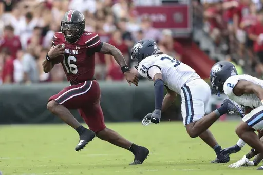 South Carolina quarterback LaNorris Sellers (16) runs away from Old Dominion linebacker Jahleel Culbreath (34) during the first half of an NCAA college football game Saturday, Aug. 31, 2024, in Columbia, S.C. (AP Photo/Artie Walker Jr.)