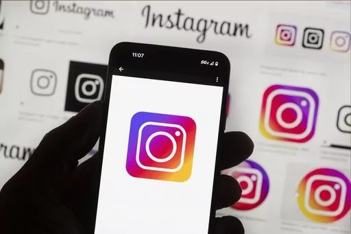 The Instagram logo is seen on a cell phone in Boston, USA, Oct. 14, 2022. Users of Meta's Facebook, Instagram, Threads and Messenger platforms are experiencing login issues in what appears to be a widespread outage. (AP Photo/Michael Dwyer, File)
