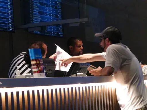 A gambler makes a sports bet at Bally's casino in Atlantic City N.J., Sept. 5, 2019. A record 31.5 million Americans plan to bet on this year's Super Bowl, according to the gambling industry's national trade group. The American Gaming Association on Tuesday, Feb. 8, 2022, released its annual predictions for wagering on pro football's championship game, forecasting that over $7.6 billion will be bet legally and otherwise. (AP Photo/Wayne Parry, File)
