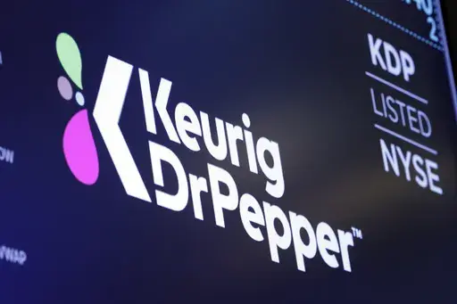 The new logo for Keurig Dr. Pepper appears above a trading post on the floor of the New York Stock Exchange, Thursday, July 12, 2018. (AP Photo/Richard Drew, File)