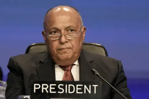 Sameh Shoukry, president of the COP27 climate summit, listens during a closing plenary session at the summit, Thursday, Nov. 17, 2022, in Sharm el-Sheikh, Egypt. (AP Photo/Nariman El-Mofty)
