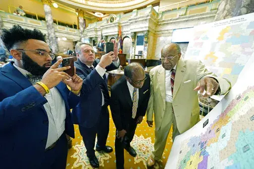 Mississippi state Sens. Rod Hickman, D-Macon, left, Michael McLendon, R-Hernando, second from left, Albert Butler, D-Port Gibson, and David Jordan, D-Greenwood, review an alternate Senate redistricting map during debate on the floor of the Senate at the Mississippi state Capitol in Jackson, Miss., March 29, 2022. The Mississippi NAACP filed a lawsuit Tuesday, Dec. 20, challenging the state House and Senate redistricting plans adopted by lawmakers in 2022 for use beginning in 2023 elections. The 