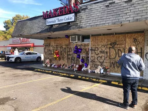 A memorial to slain rapper Young Dolph sits in front of the boarded windows at Makeda's Cookies on Thursday, Nov. 18, 2021, in Memphis, Tenn. Police said Young Dolph was fatally shot inside the popular Memphis bakery on Wednesday. (AP Photo/Adrian Sainz)