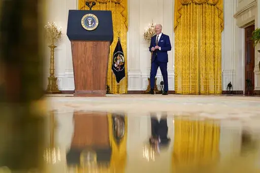 President Joe Biden arrives to speaks at a news conference in the East Room of the White House in Washington, Wednesday, Jan. 19, 2022. (AP Photo/Susan Walsh)