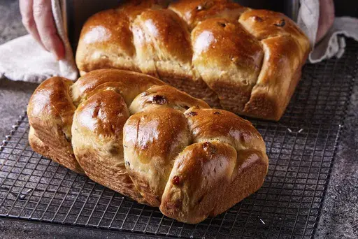 This image released by Milk Street shows a recipe for olive oil challah with golden raisins. (Milk Street via AP)