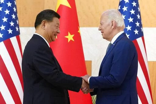 U.S. President Joe Biden, right, and Chinese President Xi Jinping shake hands before their meeting on the sidelines of the G20 summit meeting, Nov. 14, 2022, in Nusa Dua, in Bali, Indonesia. Just 40% of U.S. adults approve of how President Joe Biden is handling relations with China, a new poll shows, with a majority anxious about Beijing's influence as the White House finds its agenda increasingly shaped by global rivalries. (AP Photo/Alex Brandon, File)