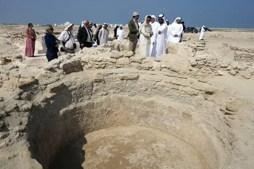 Sheikh Majid bin Saud Al Mualla, chairman of the Umm Al Quwain Department of Tourism and Archaeology, front right, explains to Noura Al Kaabi, UAE Minister of Culture and Youth, during a visit of the ancient Christian monastery on Siniyah Island in Umm al-Quwain, United Arab Emirates, Thursday, Nov. 3, 2022. The monastery possibly dating as far back as the years before Islam rose across the Arabian Peninsula has been discovered on an island off the coast of the UAE officials announced Thursday, 