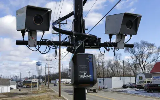 Speed cameras are aimed at U.S. Route 127, in New Miami, Ohio, Feb. 25, 2014 . Under new federal guidance issued Wednesday, Feb. 2, 2022, states can now tap billions of federal highway dollars for roadway safety programs such as automated traffic enforcement. They are being told that cameras that photograph speeding vehicles are an established way to help bring down rising traffic deaths. (AP Photo/Al Behrman, File)