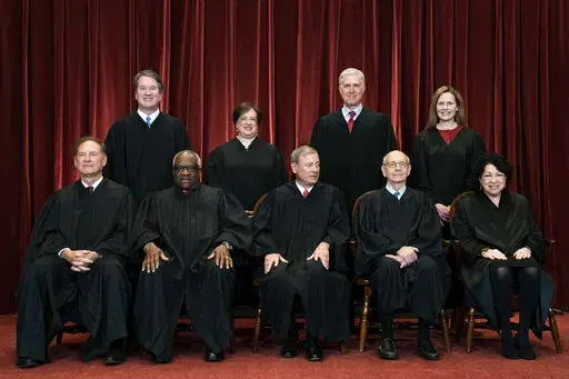 In this April 23, 2021, file photo, members of the Supreme Court pose for a group photo at the Supreme Court in Washington. Seated from left are Associate Justice Samuel Alito, Associate Justice Clarence Thomas, Chief Justice John Roberts, Associate Justice Stephen Breyer and Associate Justice Sonia Sotomayor, while standing from left are Associate Justice Brett Kavanaugh, Associate Justice Elena Kagan, Associate Justice Neil Gorsuch and Associate Justice Amy Coney Barrett. (Erin Schaff/The New 