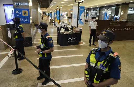 Police officers cordon off the scene near a subway station in Seongnam, South Korea, Thursday, Aug. 3, 2023. A dozen of people were injured in South Korea on Thursday when a man rammed a car onto a sidewalk and then stepped out of the vehicle and began stabbing people near a subway station in the city of Seongnam. (AP Photo/Ahn Young-joon)