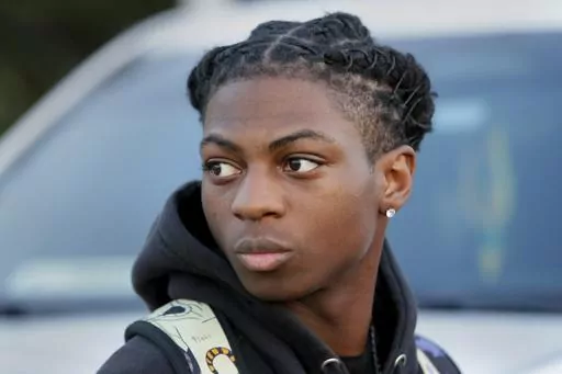Darryl George, an 18-year-old junior, looks on before walking into Barbers Hill High School after serving an in-school suspension for not cutting his hair, Sept. 18, 2023, in Mont Belvieu, Texas. The Texas high school Black student who has been disciplined and kept away from his classroom for months for refusing to change his hairstyle is not likely to be back with his regular classmates anytime soon. (AP Photo/Michael Wyke, File)