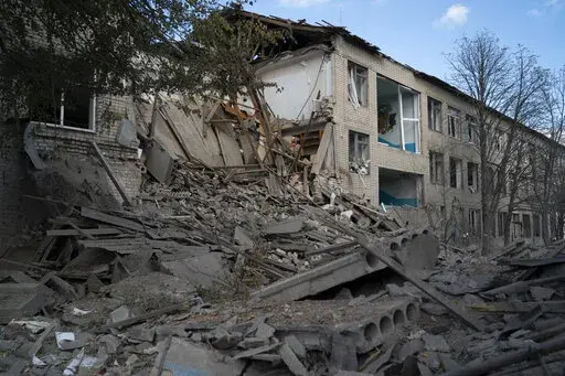 Debris covers an area of a heavily damaged school after a Russian attack, two days ago at the village of Velyka Kostromka, in Dnipropetrovsk region, Ukraine, Thursday, Oct. 13, 2022. (AP Photo/Leo Correa)