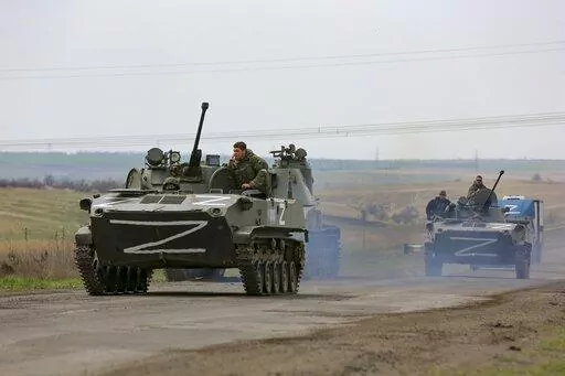 Russian military vehicles move on a highway in an area controlled by Russian-backed separatist forces near Mariupol, Ukraine, April 18, 2022. (AP Photo/Alexei Alexandrov, File)