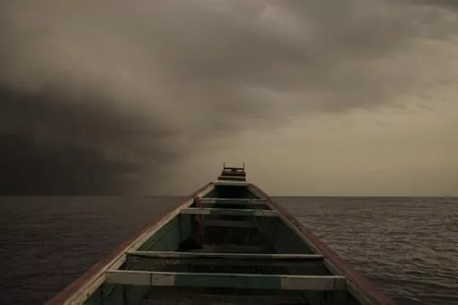 The bow of a pirogue, a typical Senegalese fishing boat that's also used by migrants bound for Europe, as a storm approaches near Dakar, Senegal, Monday, Sept. 4, 2023. (AP Photo/Felipe Dana)