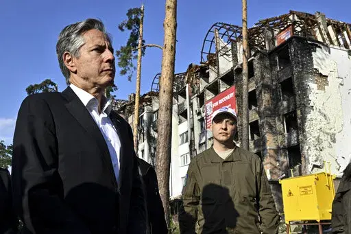 US Secretary of State Antony Blinken stands near a damaged residential building during his visit the city of Irpin, Ukraine, Thursday, Sept. 8, 2022. (Genya Savilov, Pool Photo via AP)