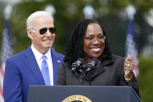President Joe Biden listens as Judge Ketanji Brown Jackson speaks during an event on the South Lawn of the White House in Washington, Friday, April 8, 2022, celebrating the confirmation of Jackson as the first Black woman to reach the Supreme Court. (AP Photo/Andrew Harnik)