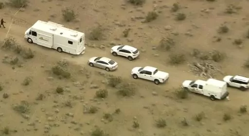 This aerial still image from video provided by KTLA shows law enforcement vehicles where several people were found shot to death in El Mirage, Calif., Wednesday, Jan. 24, 2024. Prosecutors filed murder charges Tuesday, Jan. 30, 2024, against five suspects in the fatal shootings of six men at a remote dirt crossroads in the Southern California desert after what investigators said was a dispute over marijuana. (KTLA via AP, File)