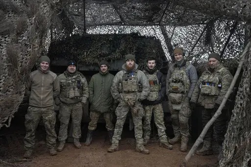 Soldiers of 12th Special Forces Brigade Azov of the National Guard pose for a photo at the 155mm self-propelled gun M109 Paladin at the front line, near Kreminna, Luhansk region, Ukraine, Sunday, Jan. 28, 2024. The U.S. has removed restrictions on the transfer of American weapons and training to a high-profile Ukrainian military unit with a checkered past, the State Department said on Tuesday, June 11, 2024. (AP Photo/Efrem Lukatsky, File)